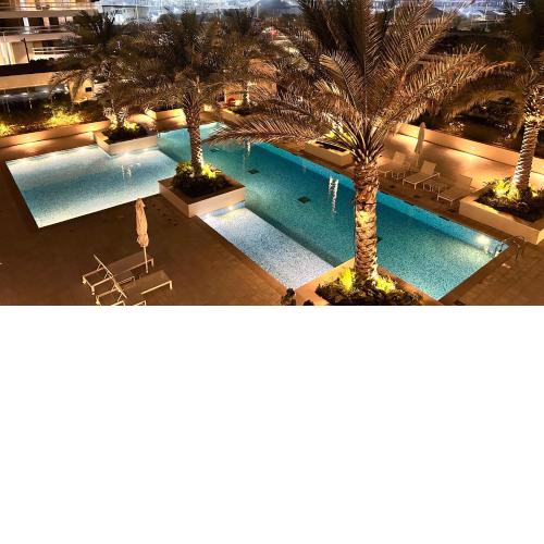 Charming 1-Bed Loft with Serene Pool View, Steps from the Beach