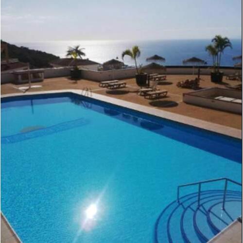House with 3 bedrooms in Costa Adeje with wonderful sea view shared pool and furnished terrace